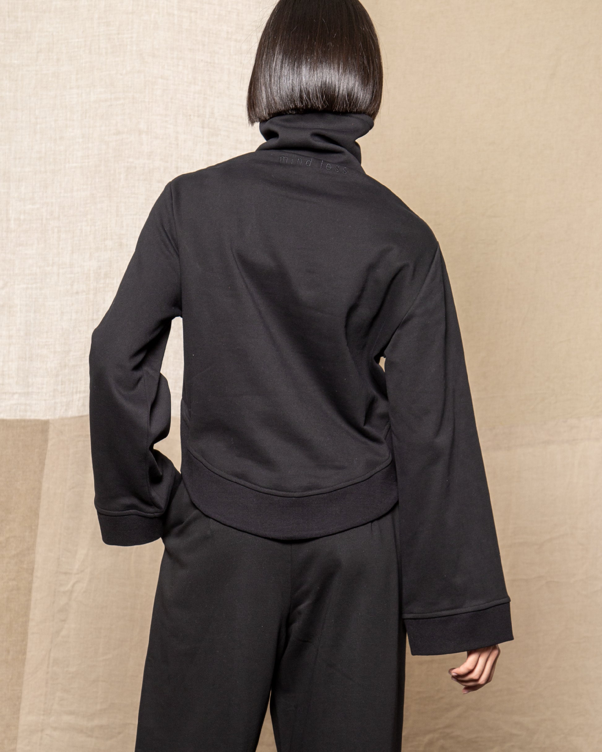 Model is wearing size Small in Black Medio Pullover by Mind Less